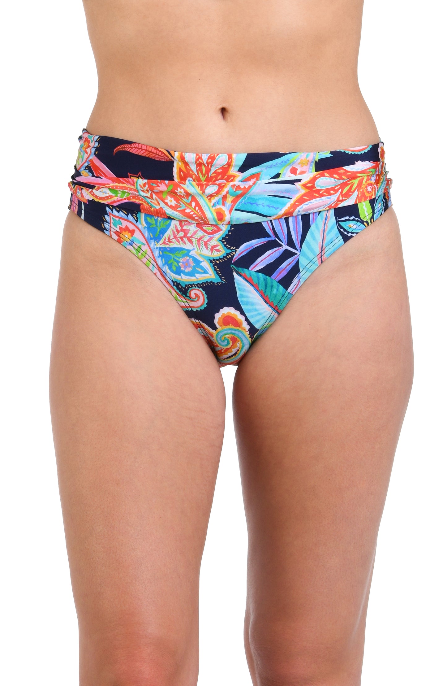 Model is wearing a pink, orange, yellow, and green multicolored tropical patterned hipster bottom against an indigo blue background.