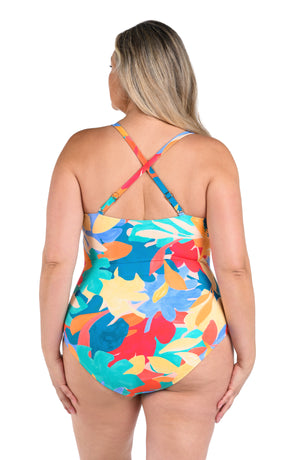 Model is wearing an orange, pink, blue, and aqua multicolored tropical patterned underwire lace front one piece swimsuit.