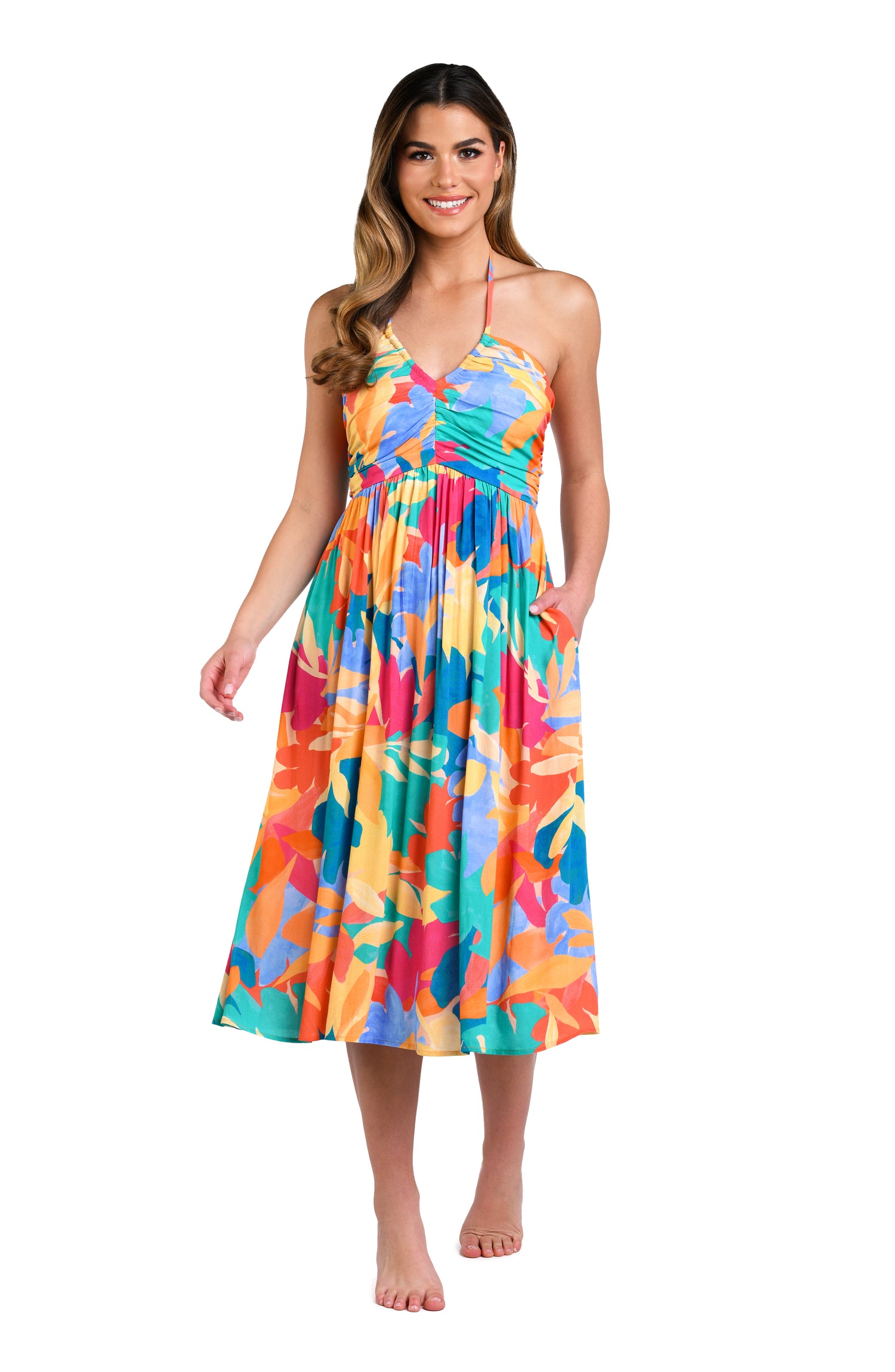Model is wearing an orange, pink, blue, and aqua multicolored tropical patterned halter midi dress cover up.