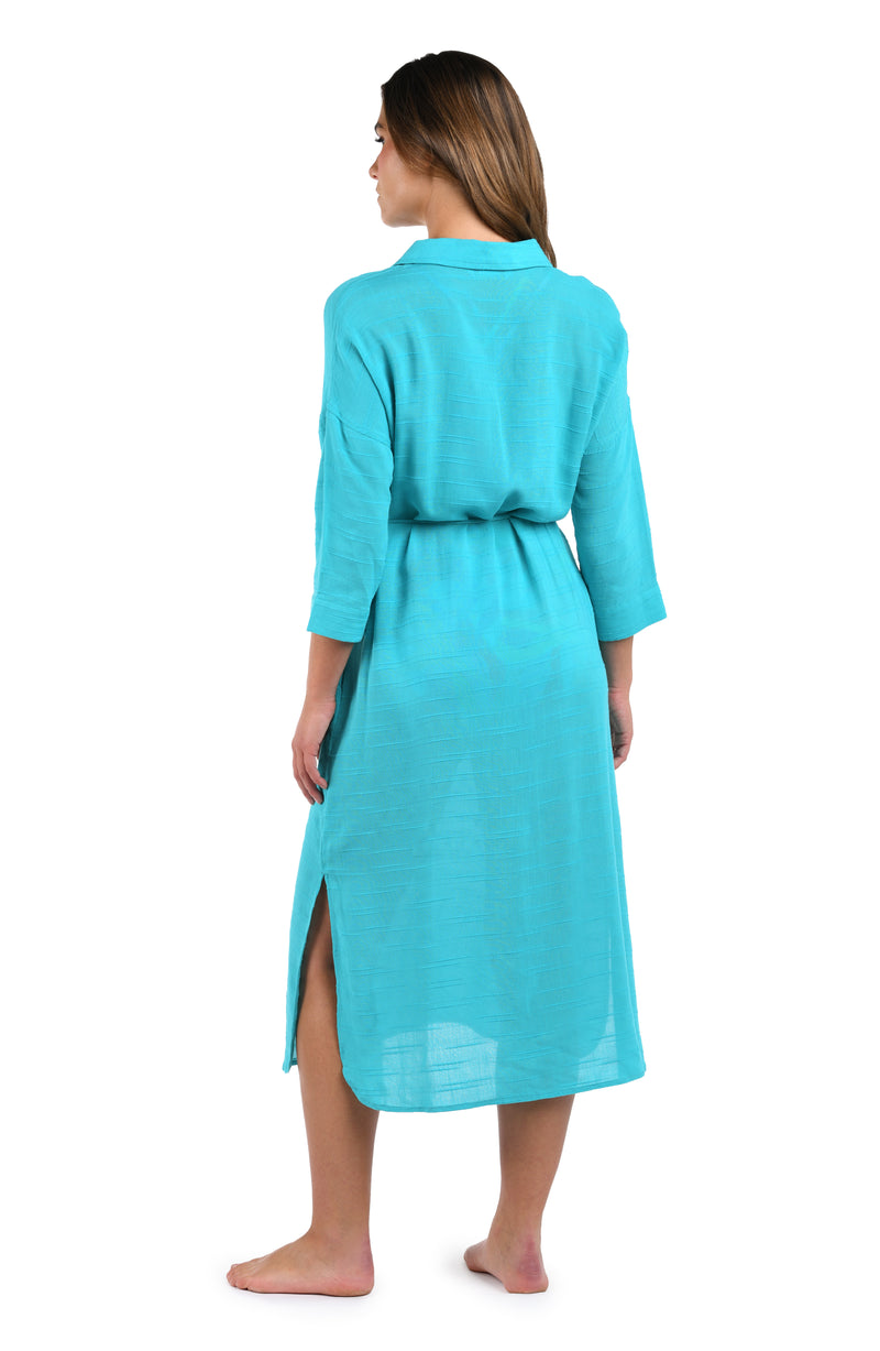 Back image of model wearing the Sea Cove Covers Button Up Shirt Dress in Teal