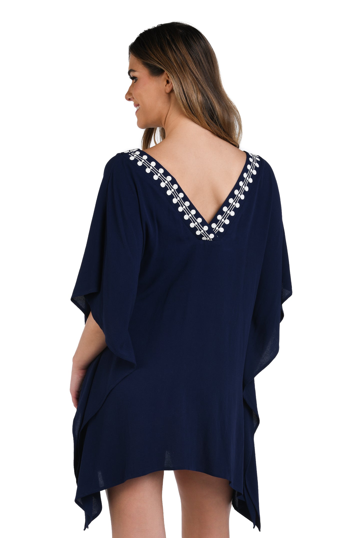 
                  
                    Model is wearing an indigo and white patterned tunic cover up that resembles a string of white sea scallop shells.
                  
                
