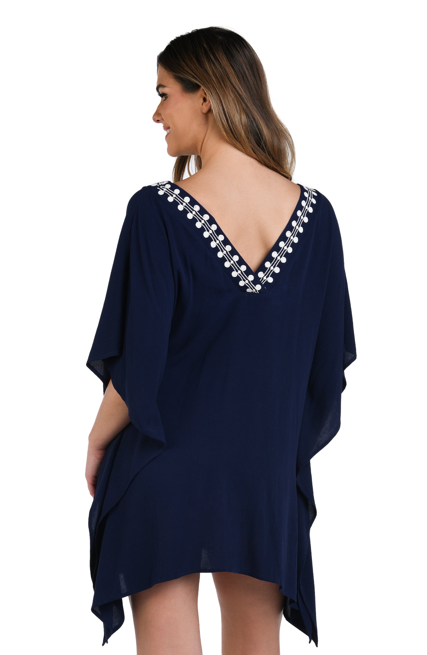 Model is wearing an indigo and white patterned tunic cover up that resembles a string of white sea scallop shells.