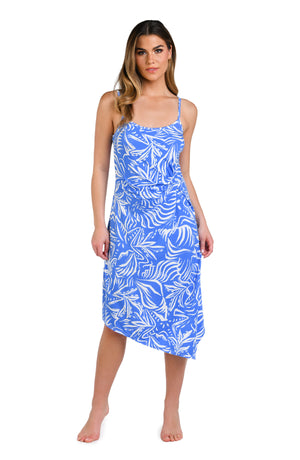 Model is wearing a two-toned midi dress cover up with bold white botanical motifs on a background of contrasting shades of blue.