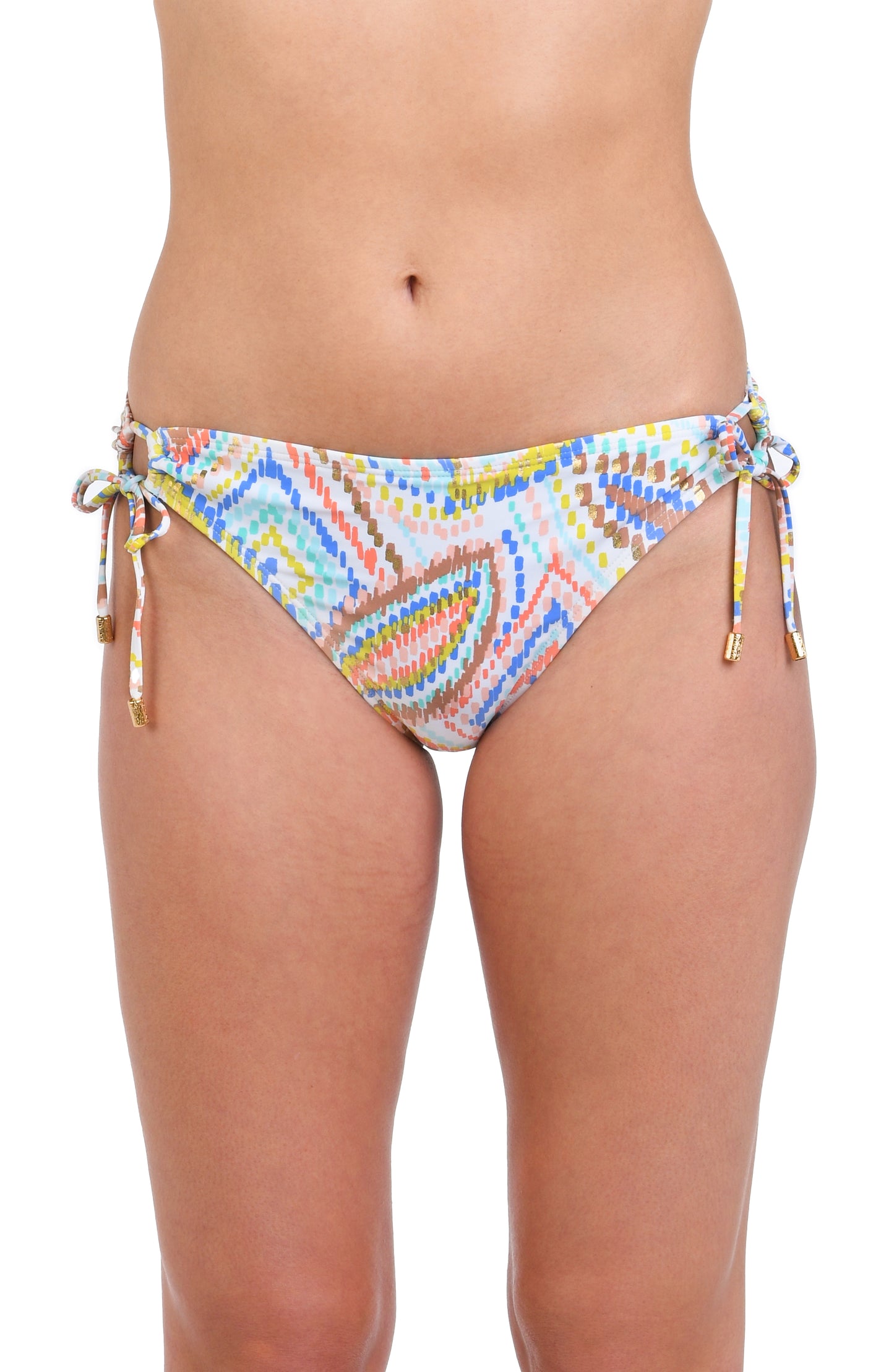 Model is wearing a geometric patterned hipster bikini bottom in pastel shades of pink, blue, and yellow, accented with sporadic glimmers of gold sequin-like details on a white background.