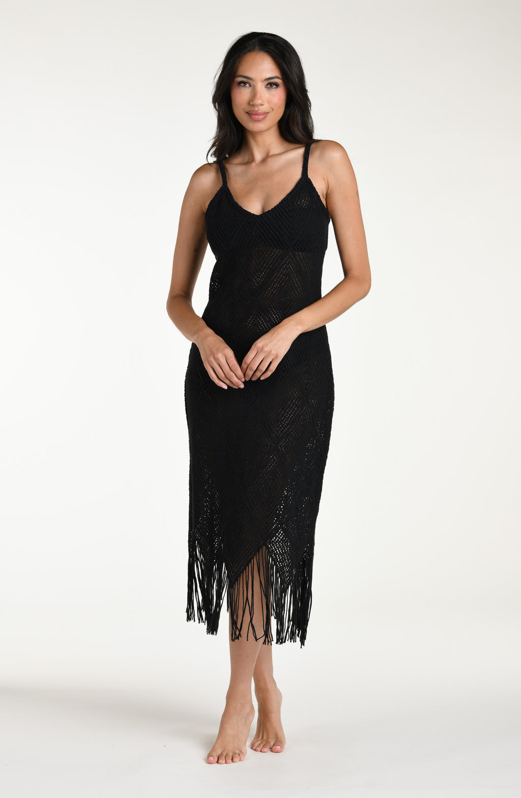 Woman wearing a black fringe midi dress against a white background