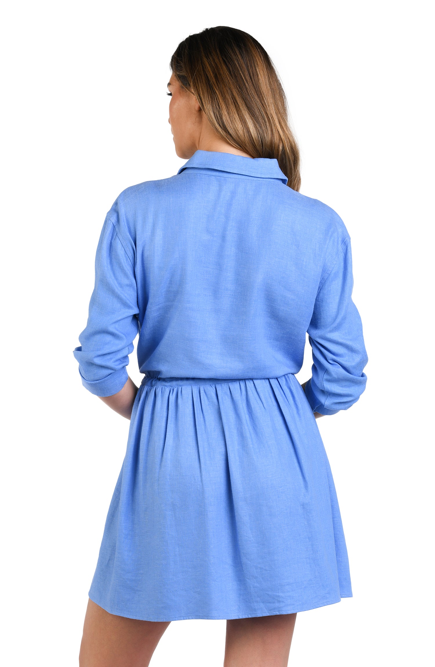 Model is wearing a solid chambray (light blue) colored tunnel shirt dress cover up.