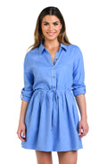 Model is wearing a solid chambray (light blue) colored tunnel shirt dress cover up.