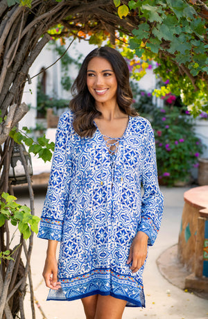 Lifestyle image of model wearing the Alboran Sea Lace Up V-Neck Tunic Cover Up.