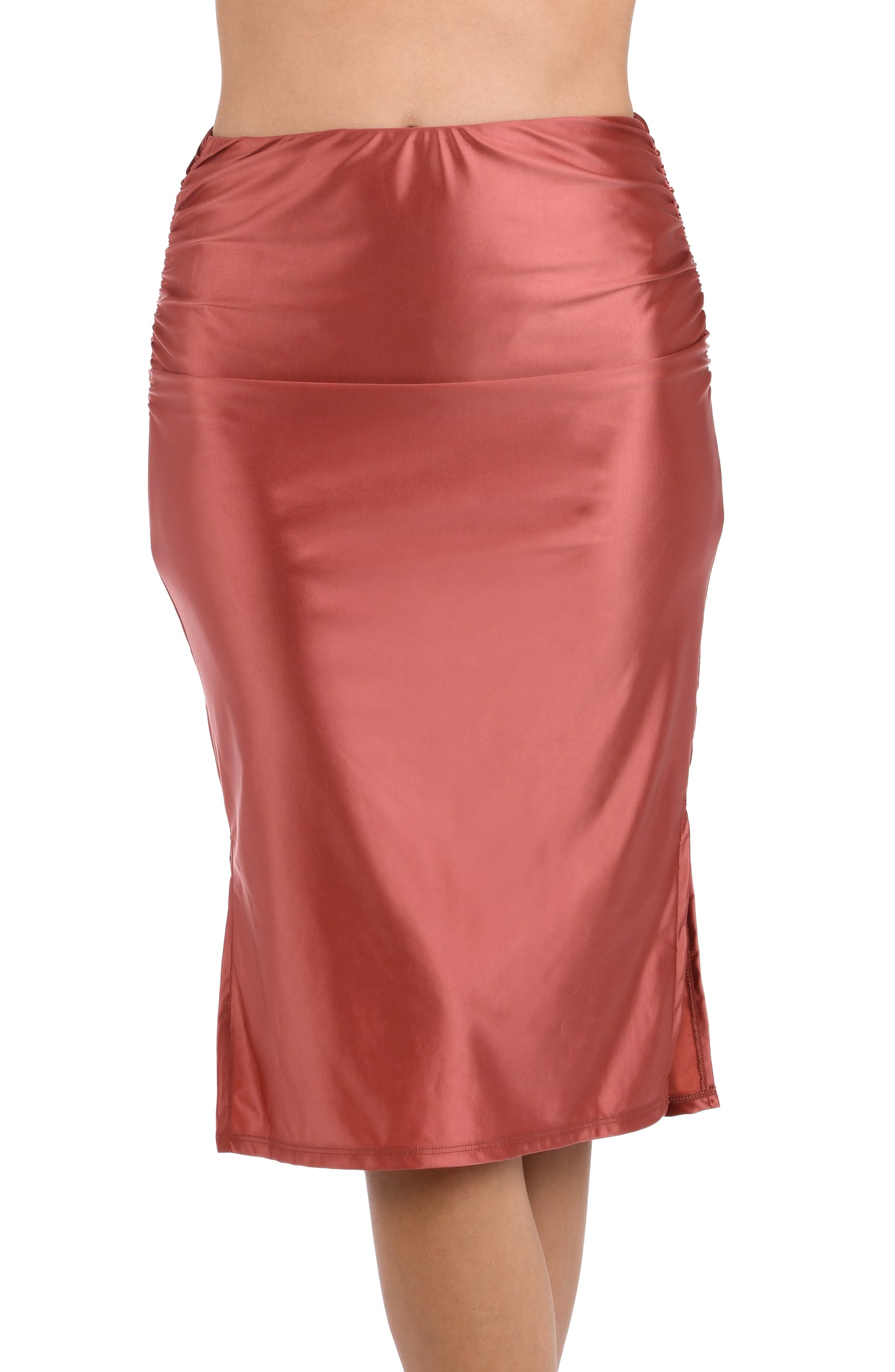 This is a front image of a model wearing a sienna colored shirred mid-length cover up skirt with side slits from the Earth Goddess swim collection.