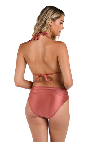 This is a back image of a model wearing a sienna colored halter triangle top with neck and back ties paired with the sienna colored twist front bottoms with moderate rear coverage from the Earth Goddess swim collection. 