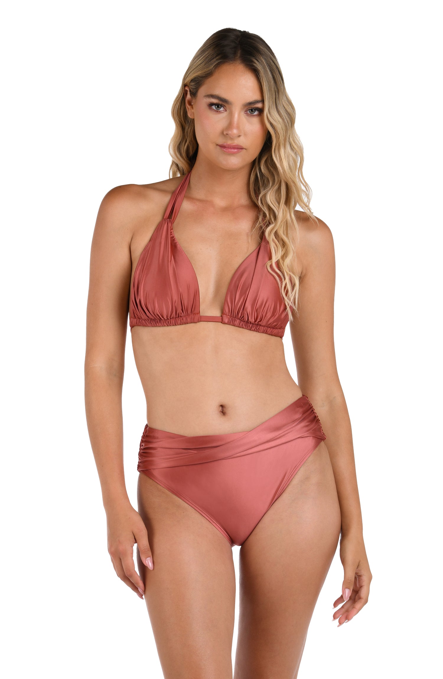 This is a front image of a model wearing a sienna colored halter triangle top paired with the sienna colored twist front bottoms from the Earth Goddess swim collection. 