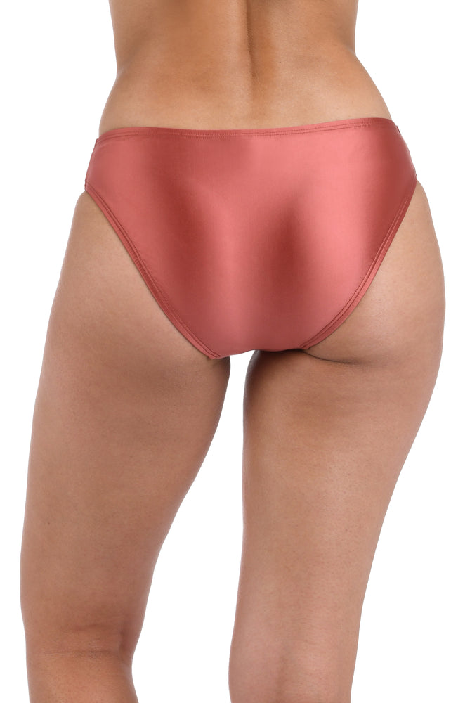 This is a back image of a model  wearing a sienna colored hipster swimsuit bottom with moderate rear coverage from the Earth Goddess swim collection.