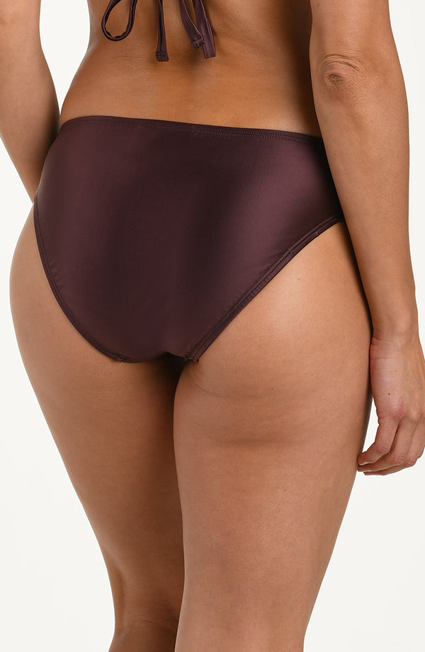Back image of model wearing basic hipster bikini bottoms in a truffle (brown) color featuring moderate rear coverage.