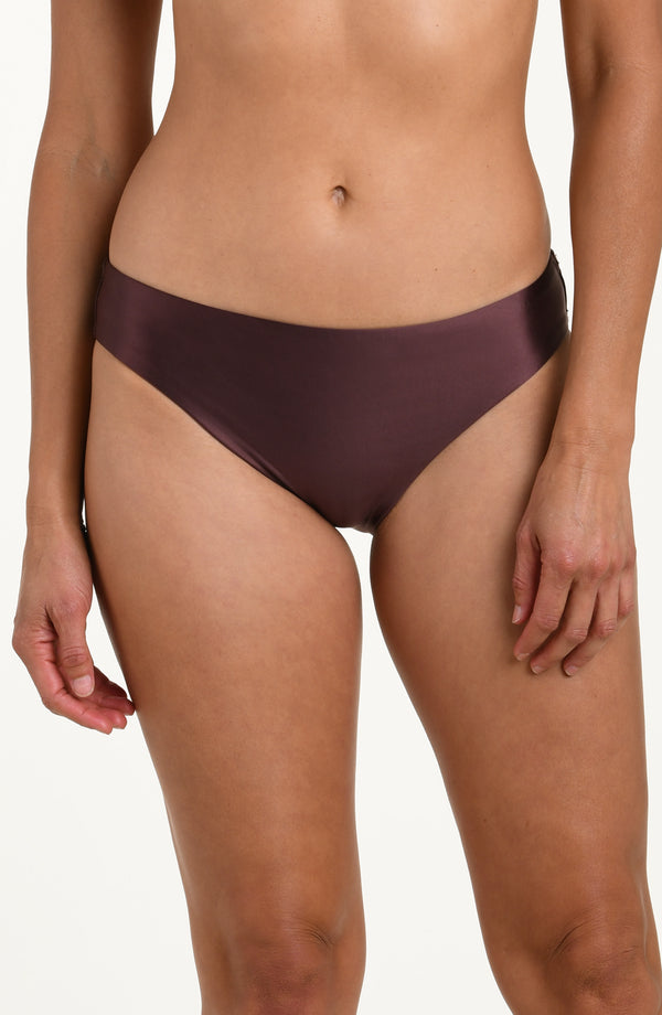Front image of model wearing basic hipster bikini bottoms in a truffle (brown) color. 