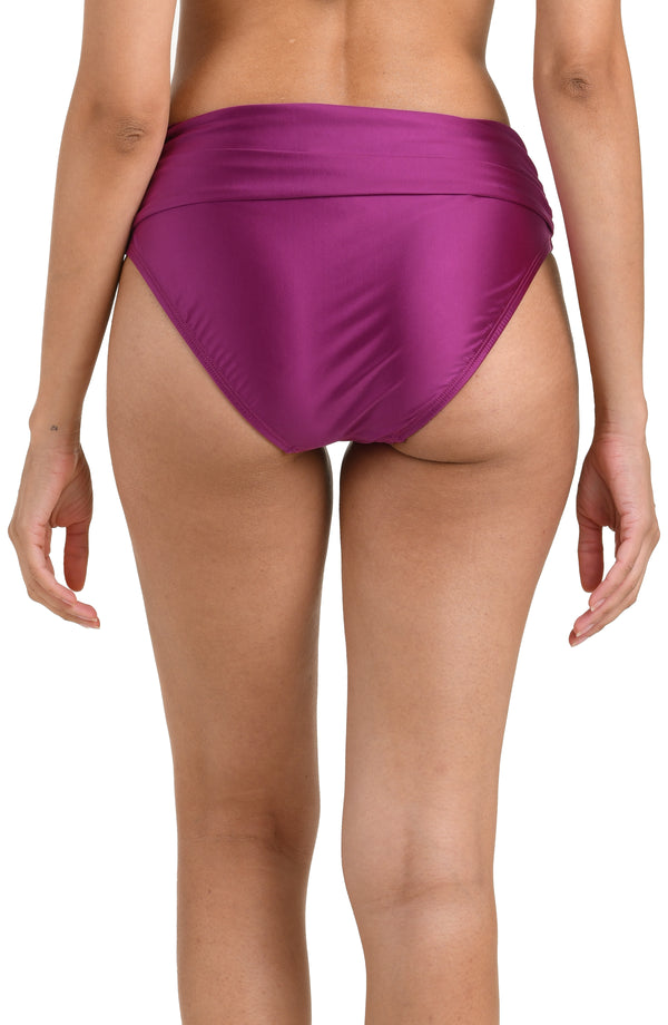 Back image of model wearing a berry colored bikini bottom with a mid-rise fit, banded, and moderate rear coverage.