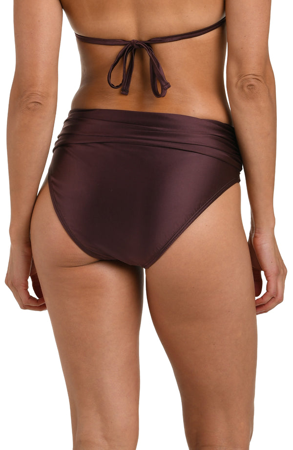 Back image of model wearing a truffle (brown) colored bikini bottom with a mid-rise fit, banded, and moderate rear coverage.