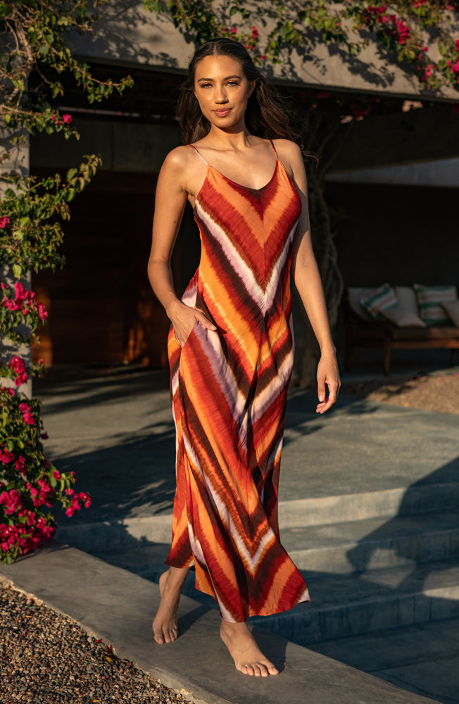 Model is wearing an Upon the Horizon Over the Shoulder Maxi Dress.