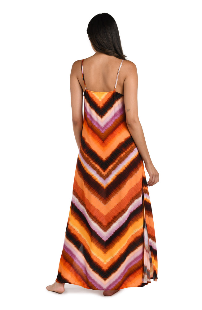 Model is wearing an Upon the Horizon Over the Shoulder Maxi Dress.