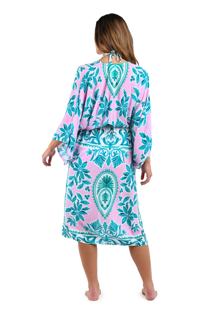 Back image of model wearing the Opulent Palm Kimono in multi color green and pink.