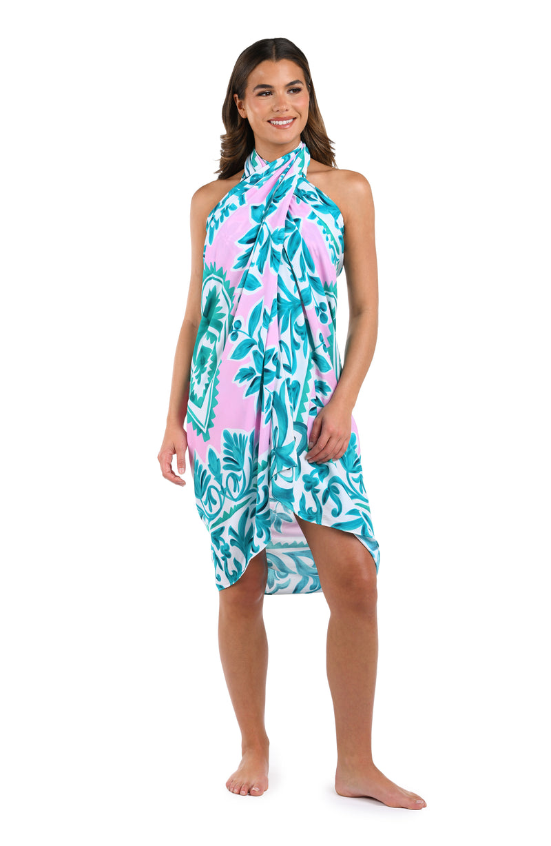 Front image of model wearing the Opulent Palm Pareo Wrap Cover Up in multi color green and pink.