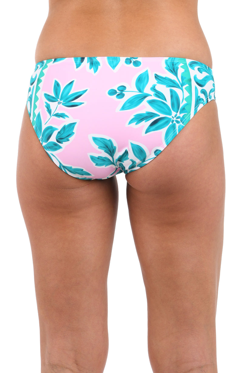 Back image of model wearing the Opulent Palm Hipster Bottom in multi color green and pink.