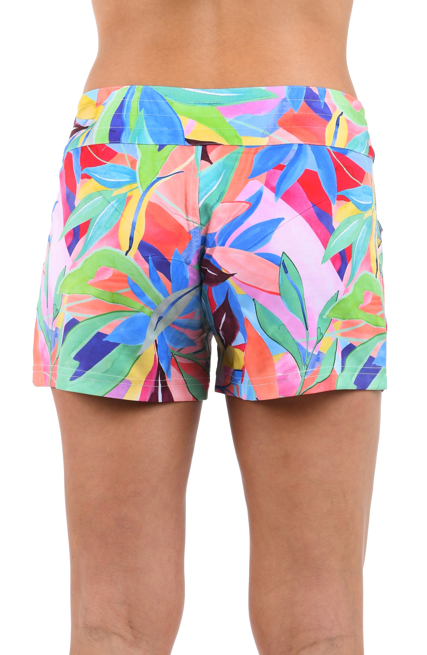 Back image of model wearing the Tropi-flage 3" Inseam Board Short in a bright multi colored tropical print.