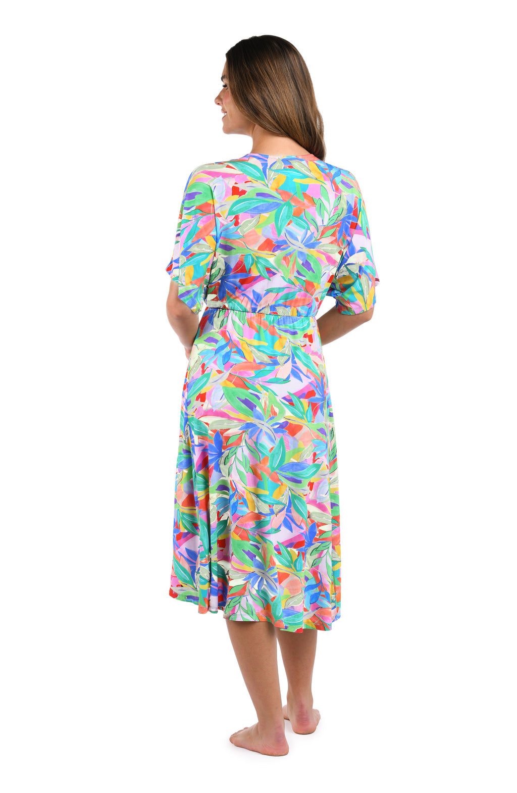 Full body back image of model wearing a multicolored tropical printed midi cover up dress. 