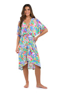 Full body front image of model wearing a multicolored tropical printed midi cover up dress. 
