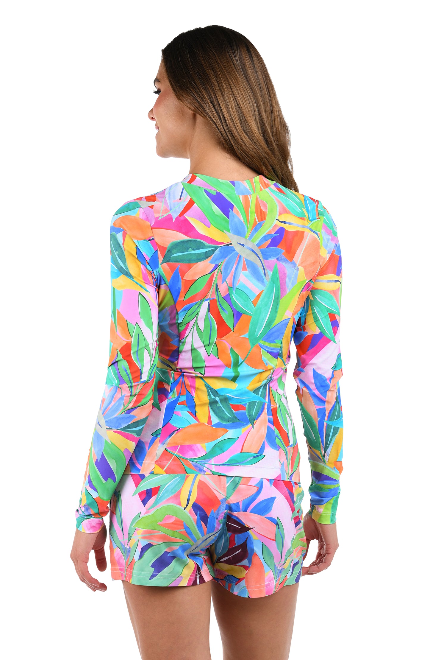 Back image of model wearing the Tropi-flage Half Zip Rashguard in a bright multi colored tropical print.