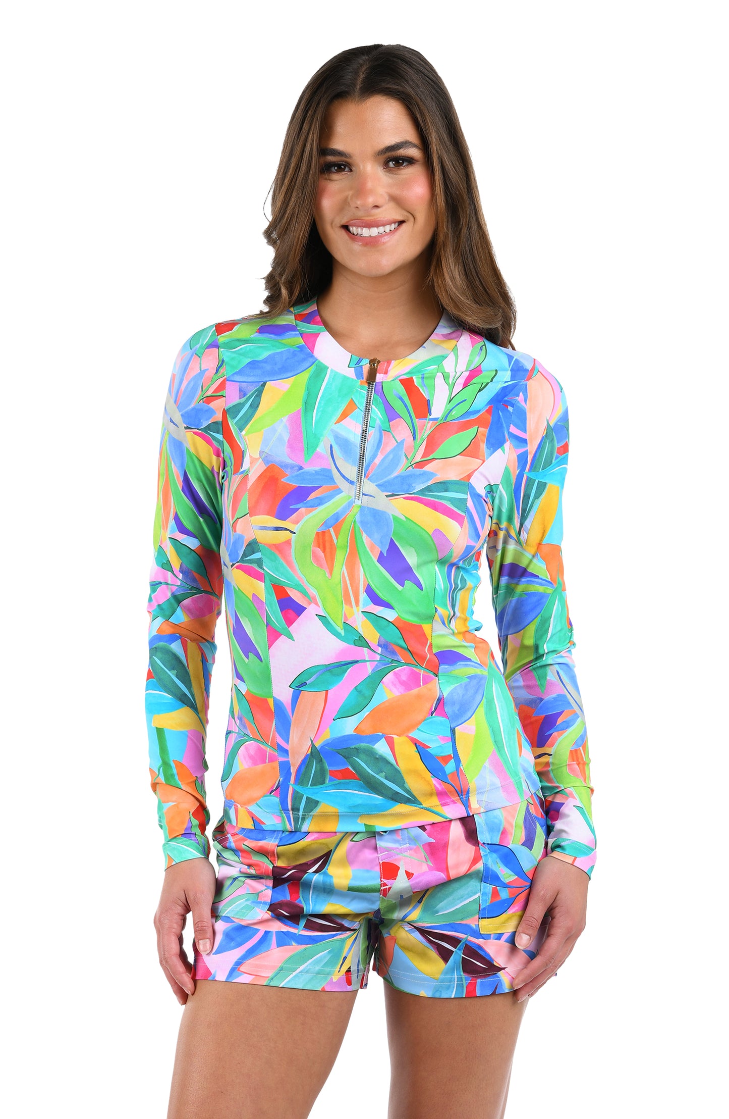 Front image of model wearing the Tropi-flage Half Zip Rashguard in a bright multi colored tropical print.