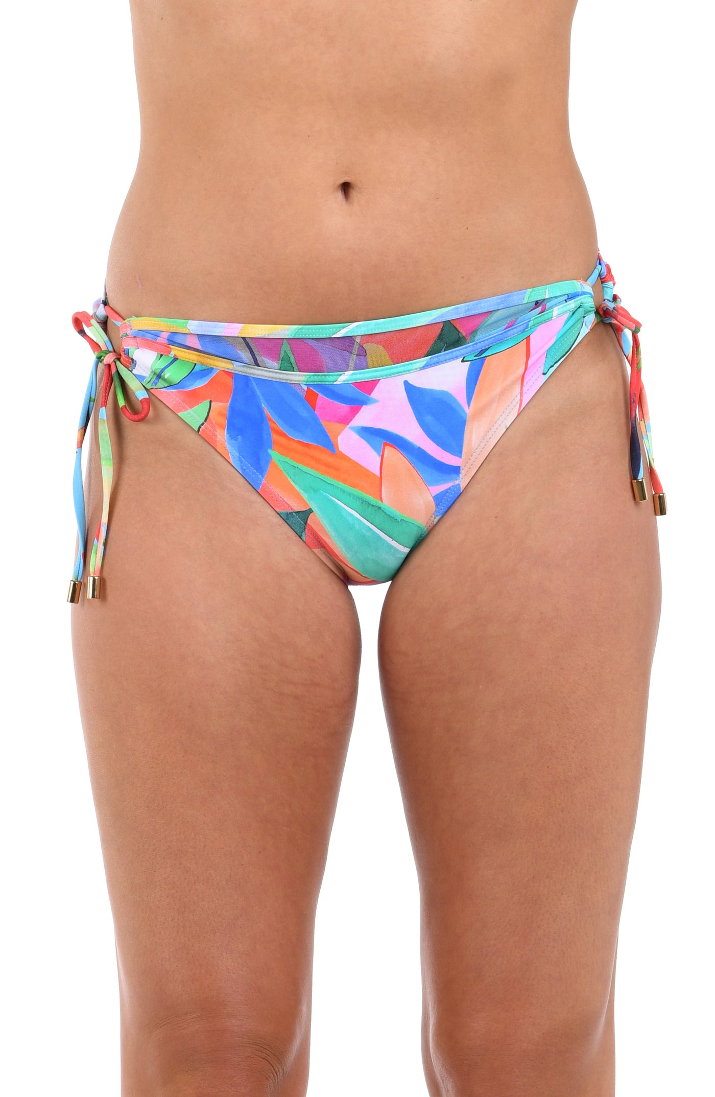 
                  
                    Front image of model wearing the Tropi-flage Side Tie Hipster Bottom in a bright multi colored tropical print.
                  
                
