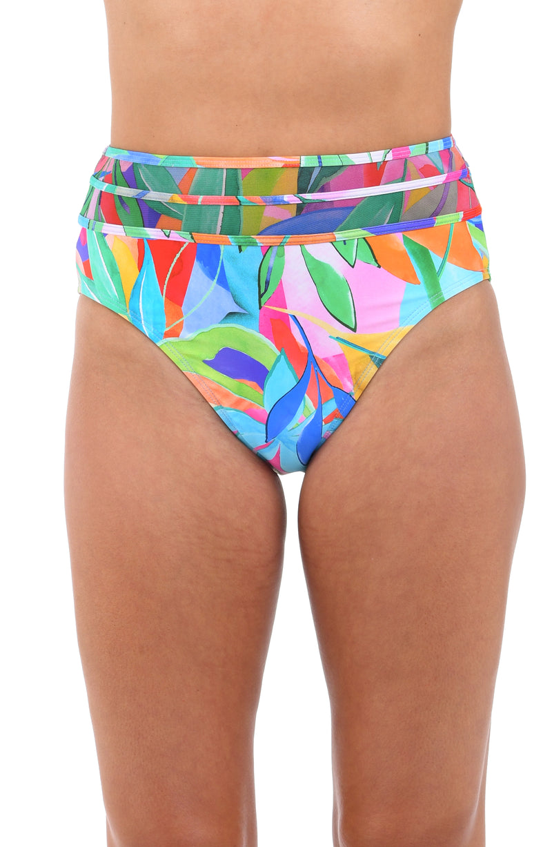 Front image of model wearing the Tropi-flage High-Waist Bottom w/ Mesh Detail in a bright multi colored tropical print.