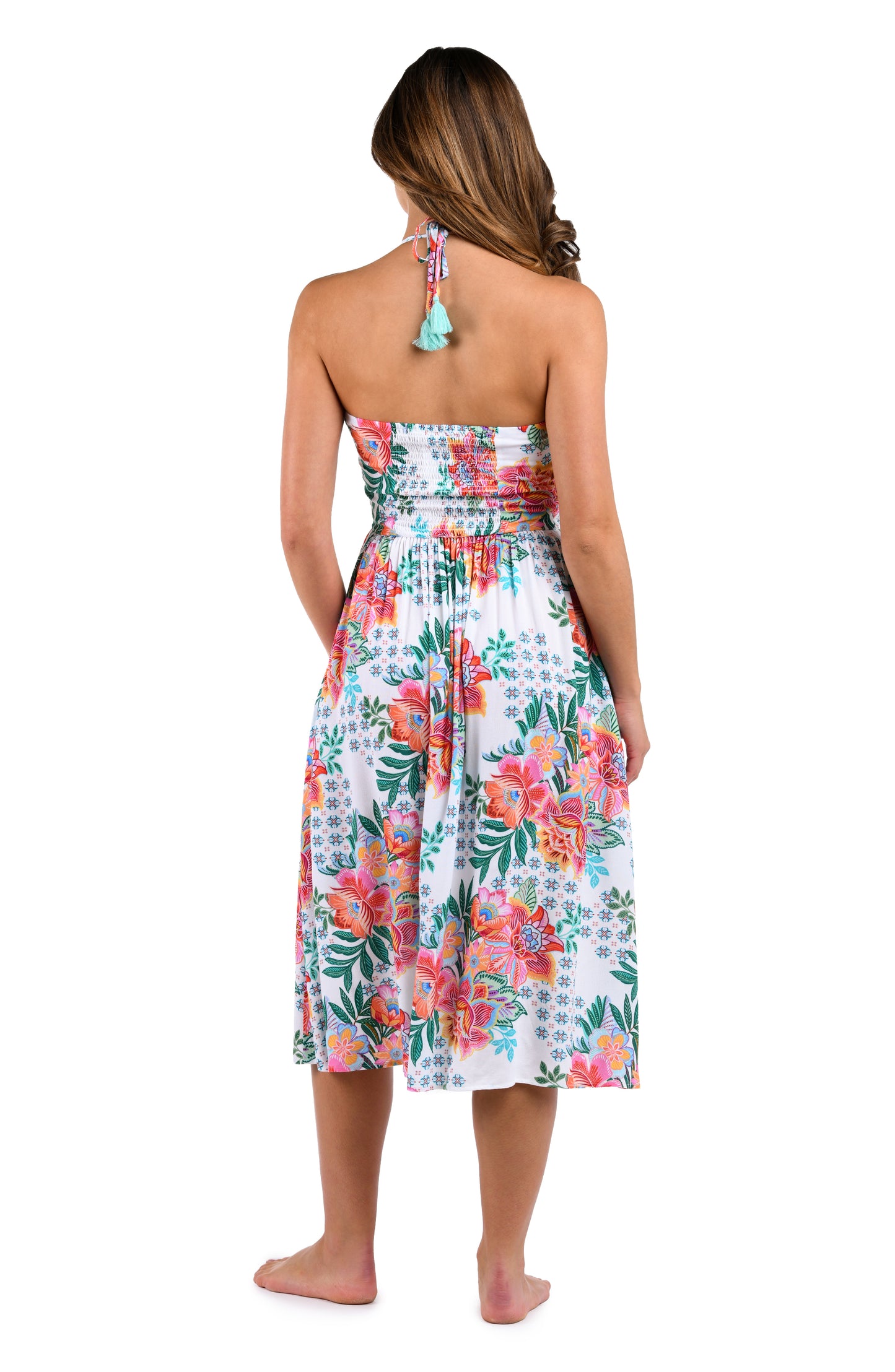 Back image of model wearing the Riviera Resort Halter Midi Dress Cover Up in a white multi colored tropical print.