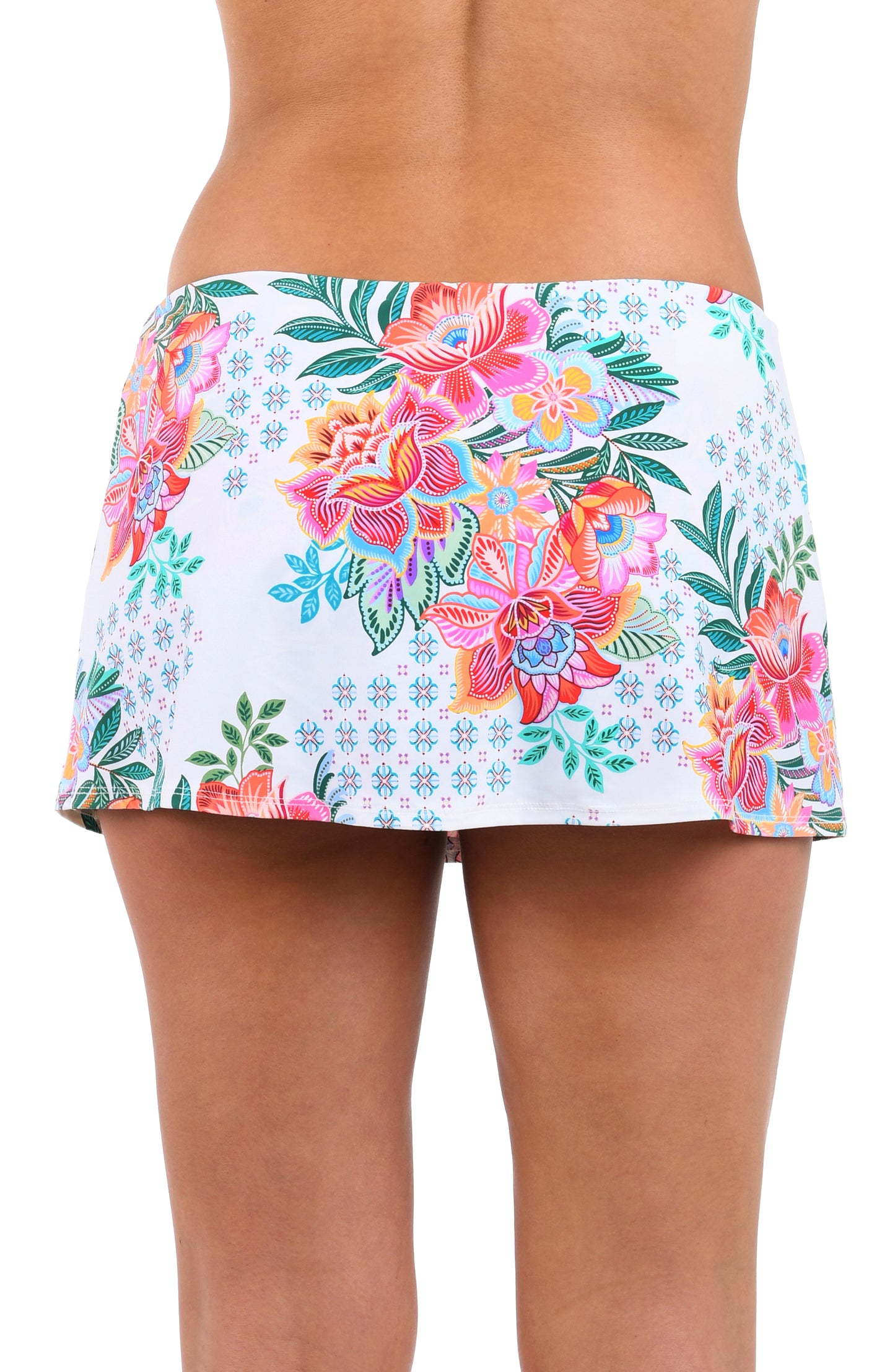 Back image of model wearing the Riviera Resort Adjustable Tunnel Skirted Bottom in a white multi colored tropical print.