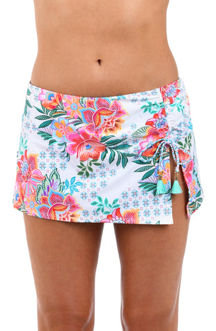 Front image of model wearing the Riviera Resort Adjustable Tunnel Skirted Bottom in a white multi colored tropical print.