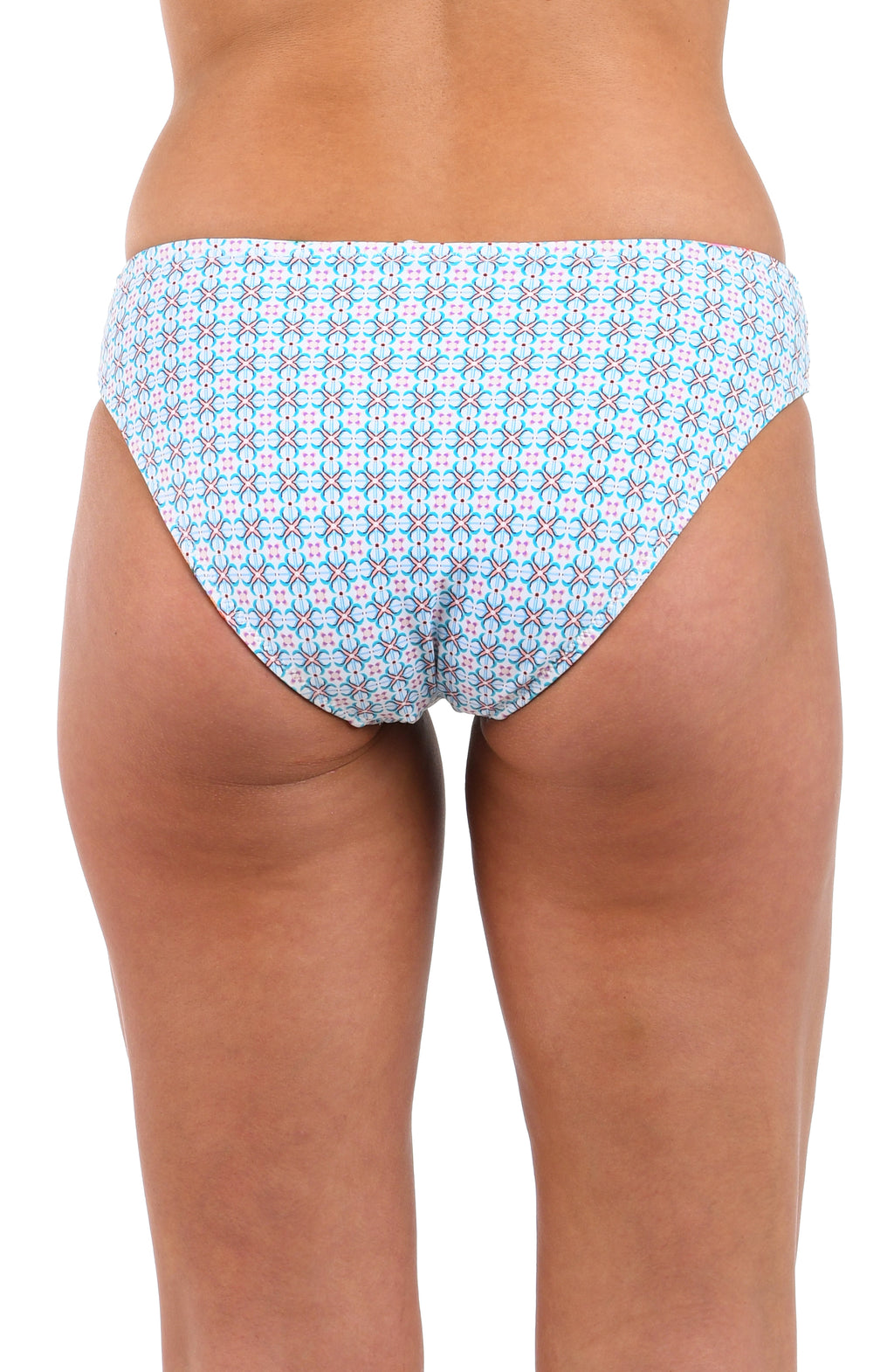 Reverse back image of model wearing the Riviera Resort Reversible Hipster Bottom in a light blue multi colored geometric print.