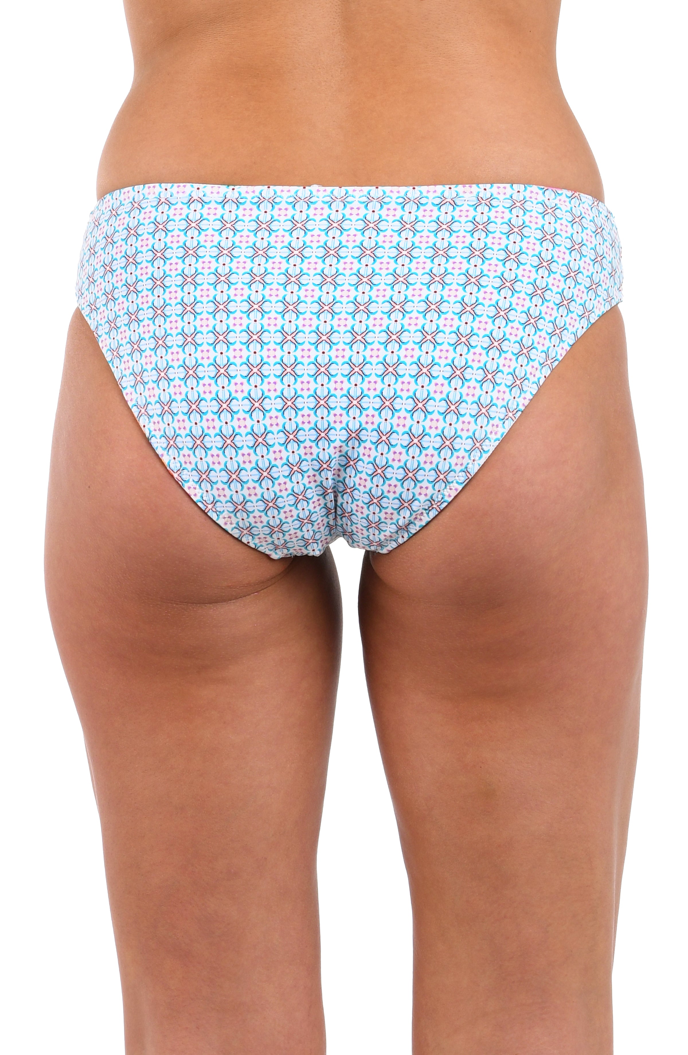Reverse back image of model wearing the Riviera Resort Reversible Hipster Bottom in a light blue multi colored geometric print.