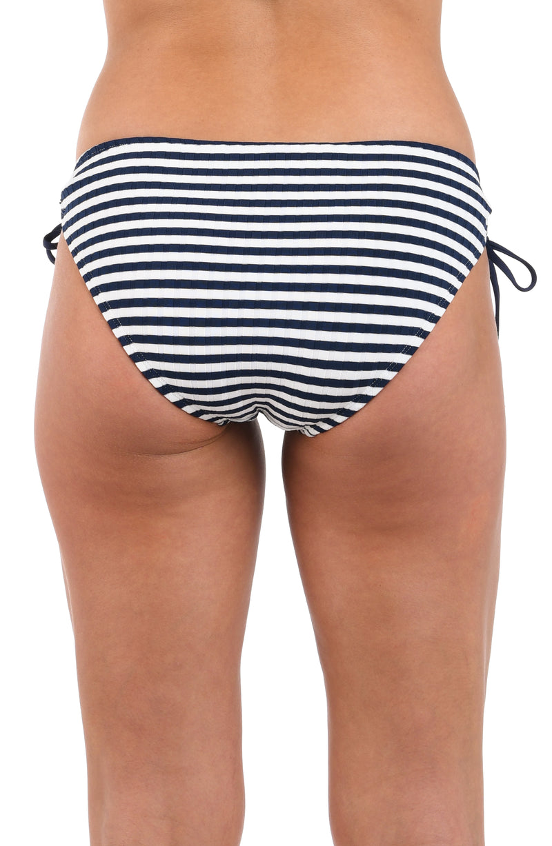 Back image of model wearing the Set Sail Side Tie Hipster Bottom in white and indigo.