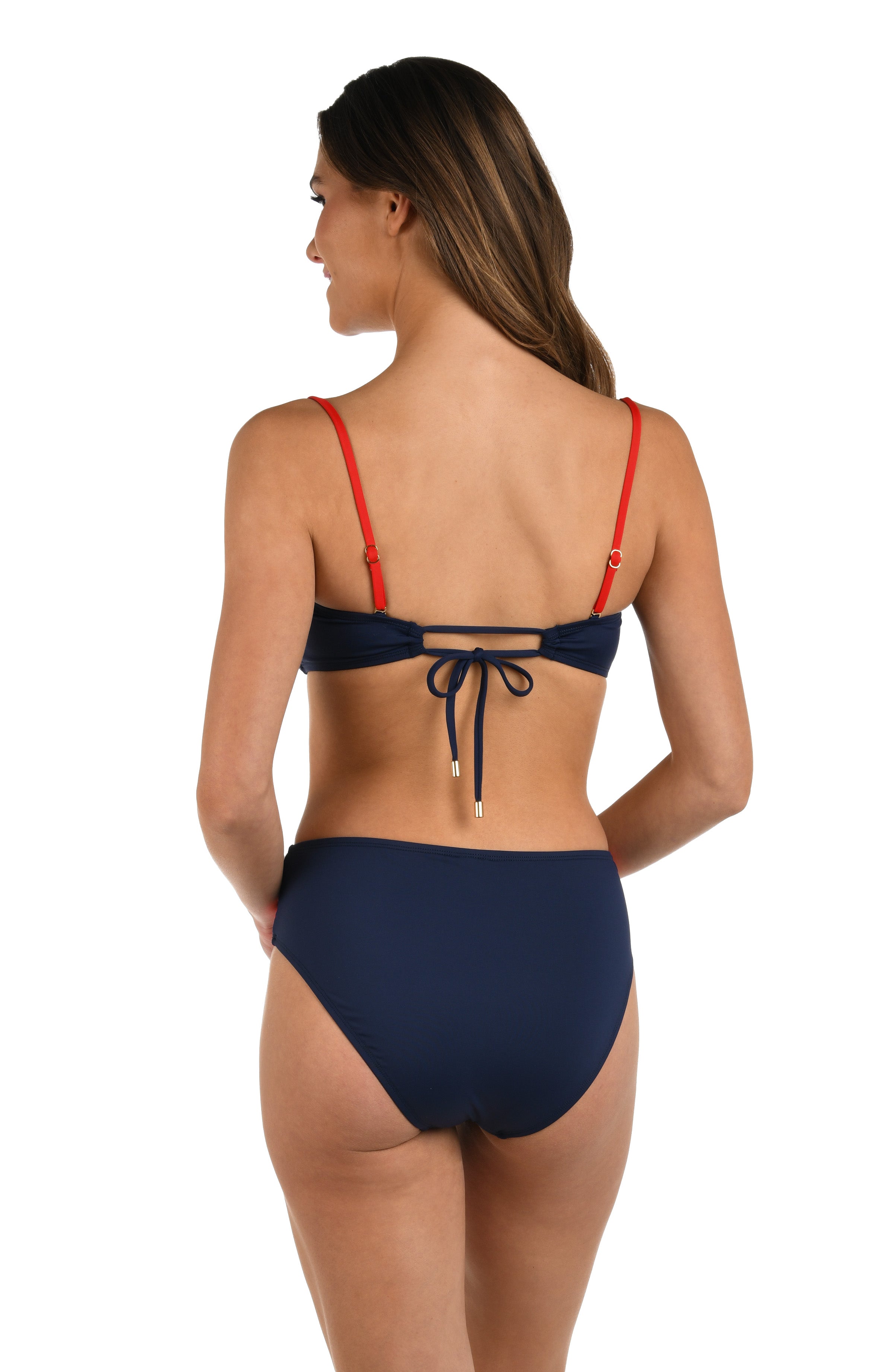 Back image of model wearing a red, white, and blue color block bandeau bikini top featuring red removable straps and indigo tie-back closure with a center cut-out with gold cord ends.