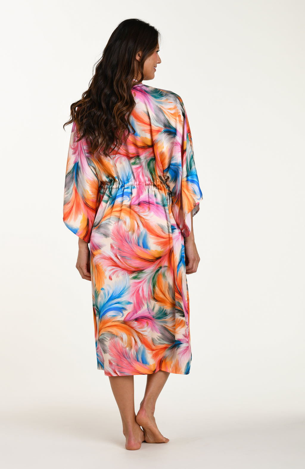 Full body back image of model wearing a multicolored feather printed long kimono-style cover-up featuring wide sleeves and a drawstring waist.