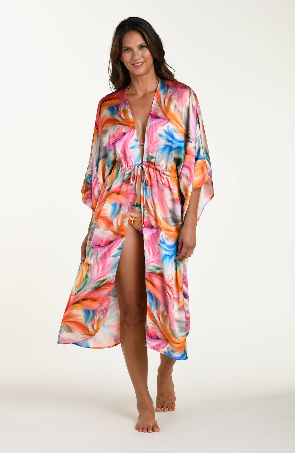 Full body front image of model wearing a multicolored feather printed long kimono-style cover-up featuring wide sleeves and a drawstring waist.