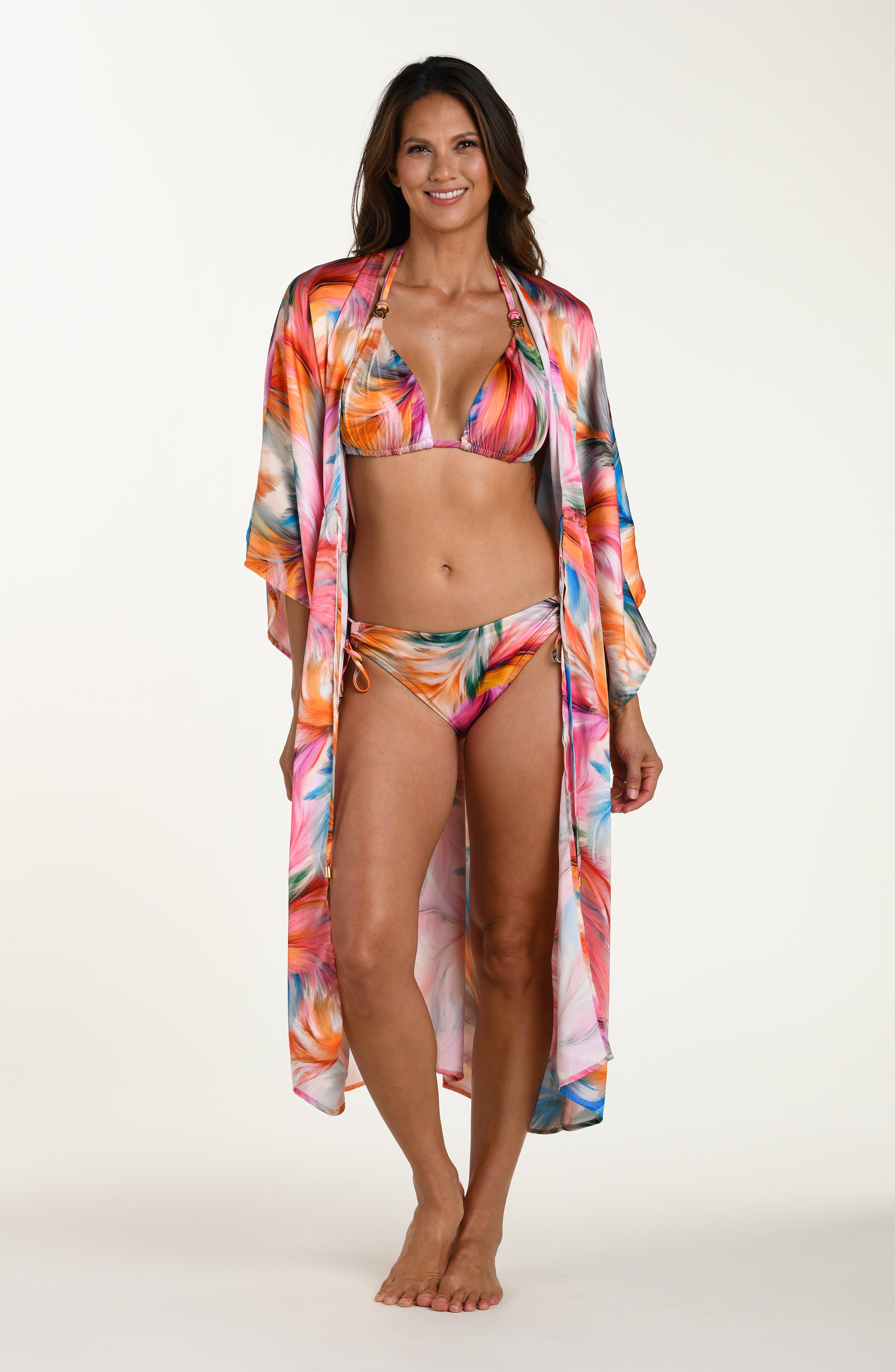 Full body front image of model wearing a multicolored feather printed long kimono-style cover-up featuring  wide sleeves and a drawstring waist. 