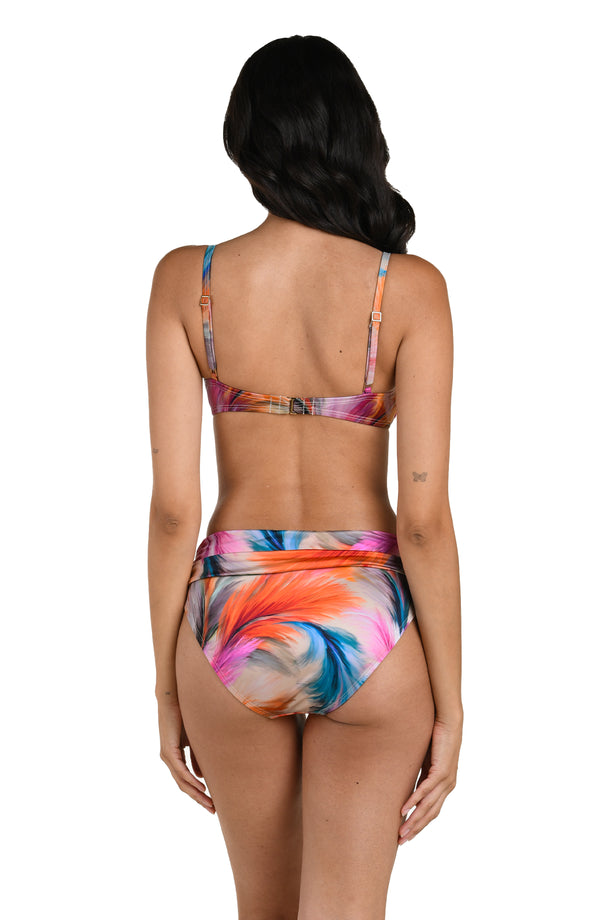 Back image of model wearing a multicolored feather printed bikini top with adjustable thin straps and a hook-back closure. This is paired with matching bikini bottoms.