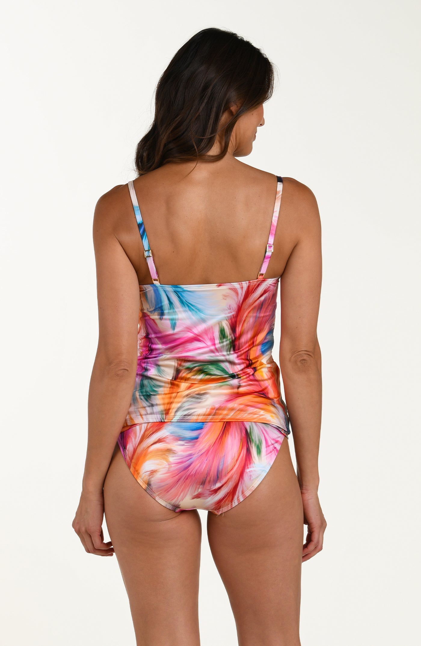 
                  
                    Full body back image of model wearing a multicolored feather printed tankini top with thin over the shoulder straps, straight back, and gold rectangular accents at the neckline. This is paired with matching bikini bottoms.
                  
                