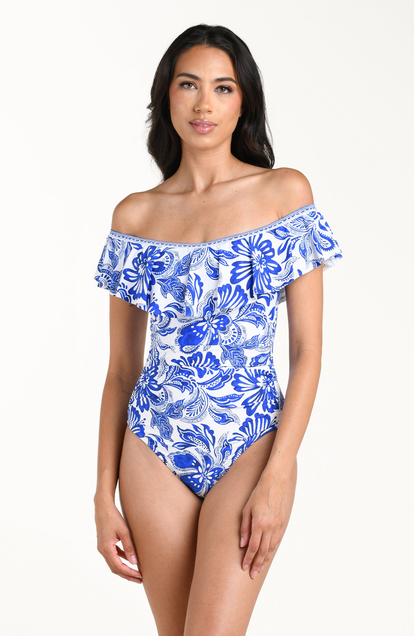 
                  
                    Woman wearing a blue and white floral off-shoulder swimsuit on a white background
                  
                