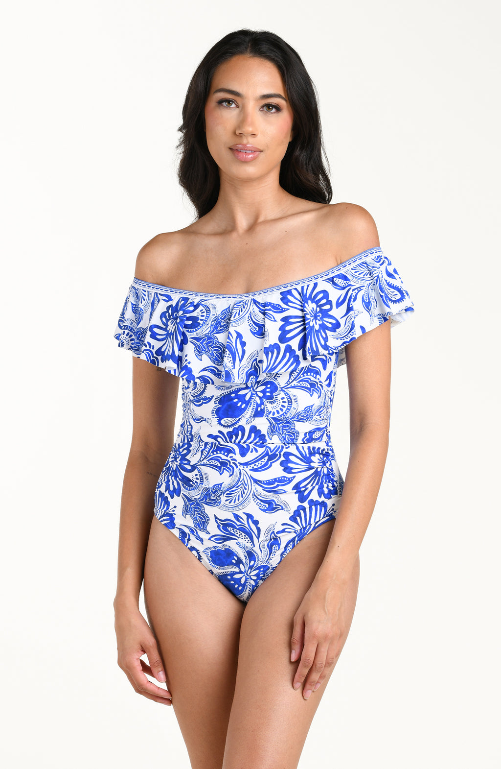 Woman wearing a blue and white floral off-shoulder swimsuit on a white background