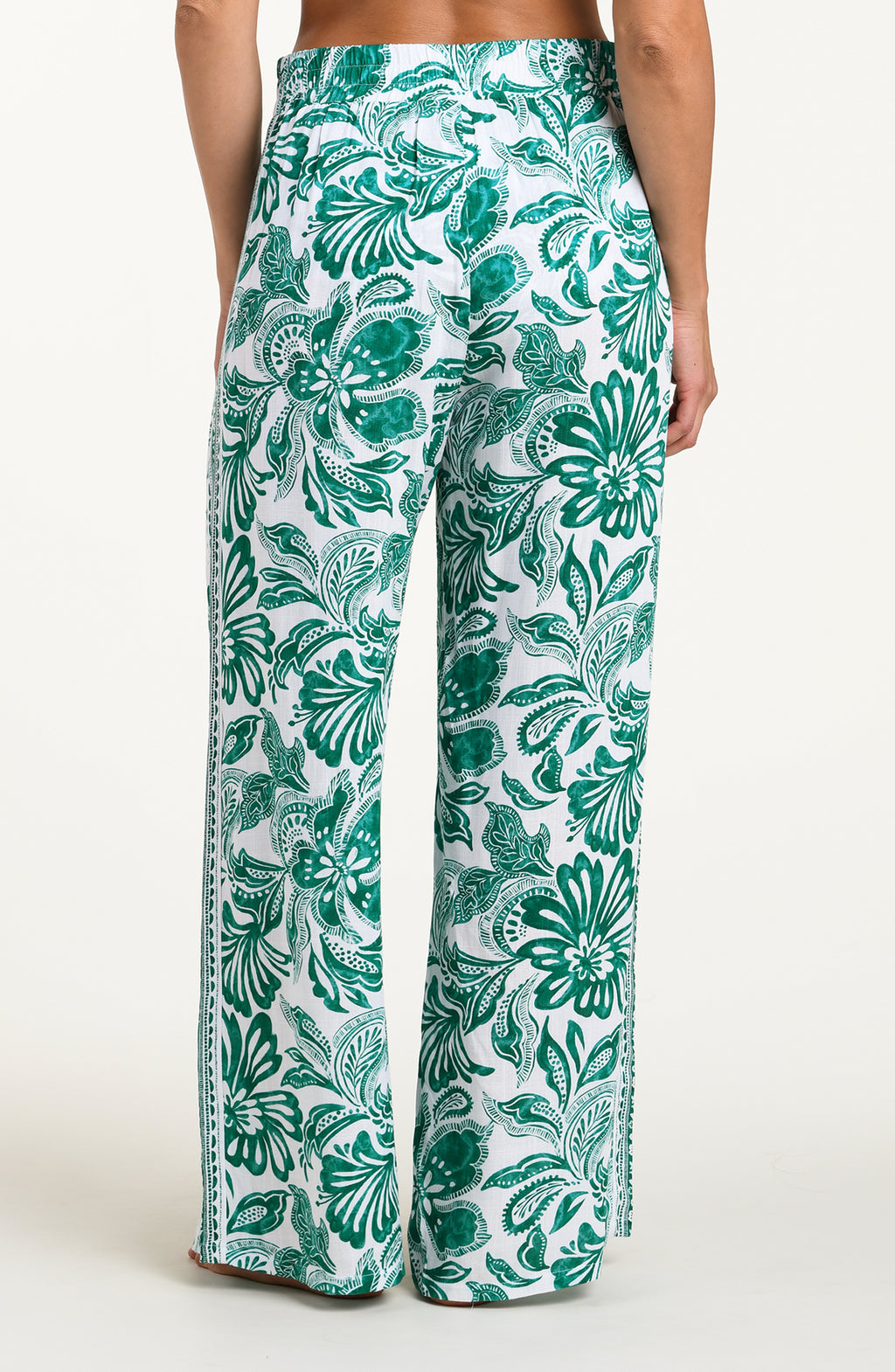 Green and white floral-patterned pants on a white background