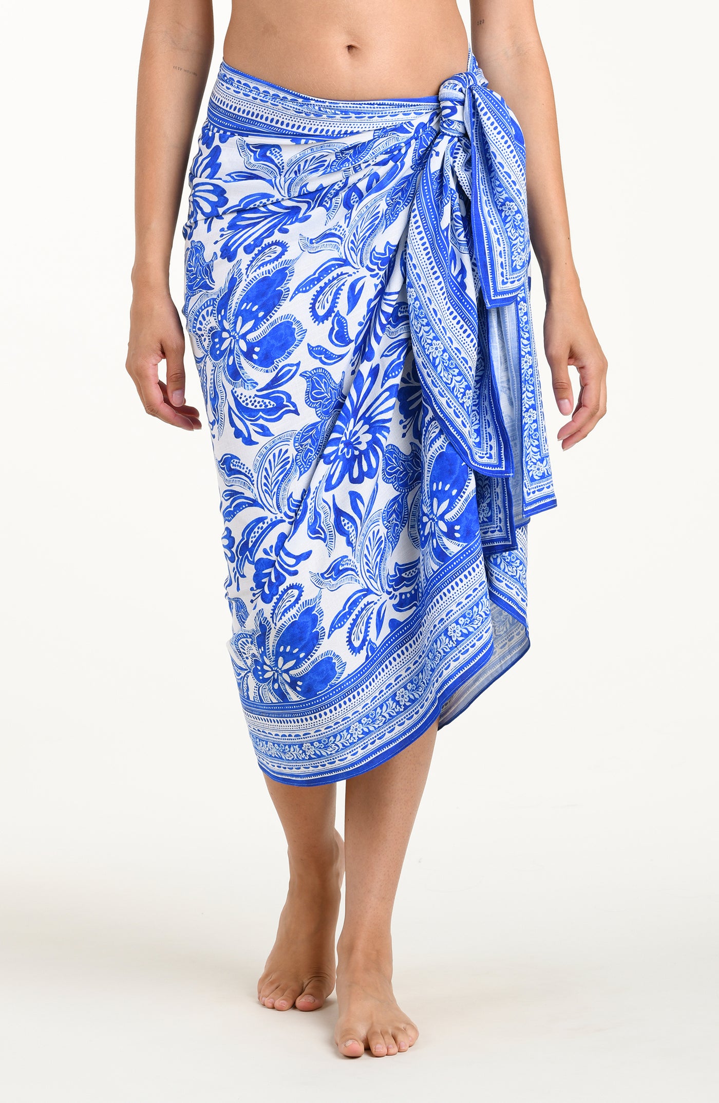 
                  
                    Blue and white patterned sarong on a person against a white background
                  
                