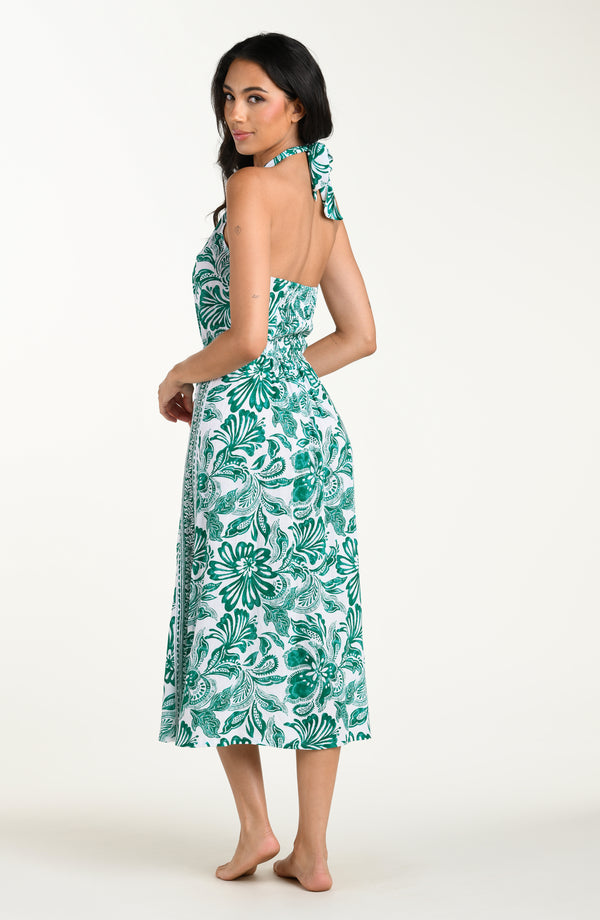 Woman wearing a green floral dress on a white background
