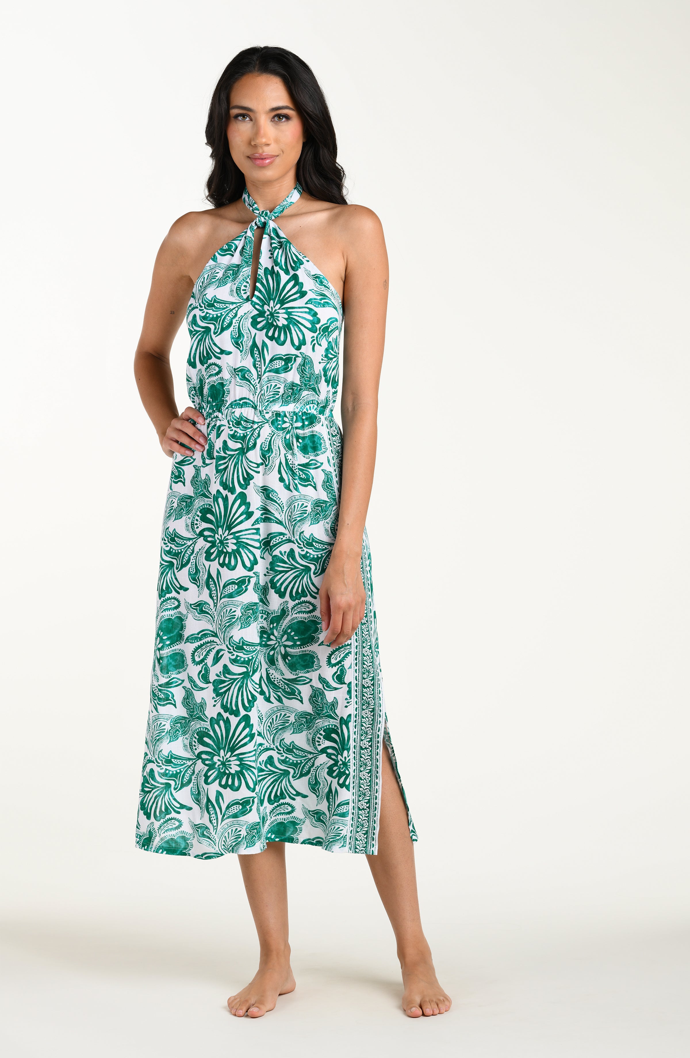Woman wearing a green floral dress on a white background